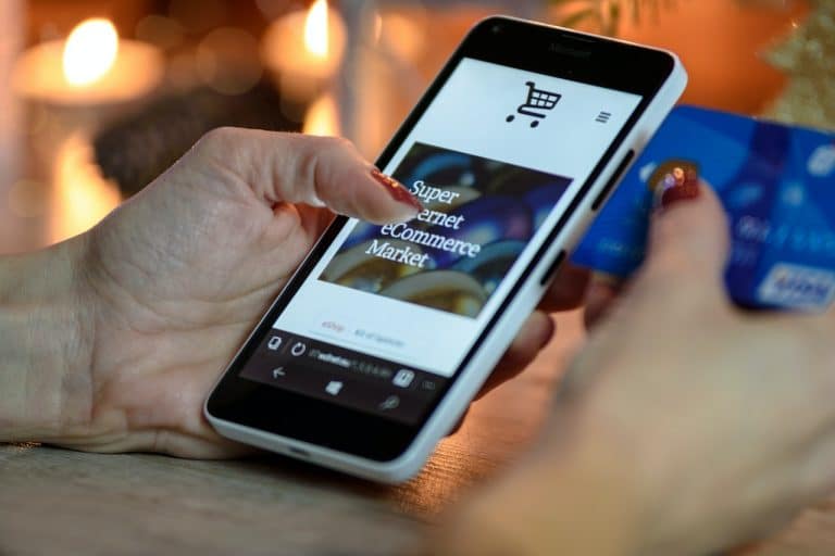 A person holding a phone on an ecommerce site.